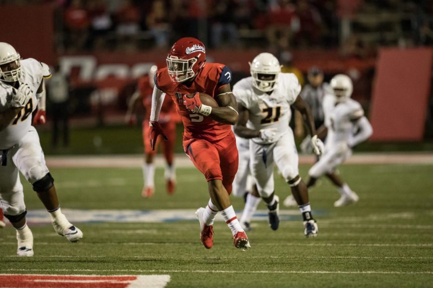Photo of Mykal Walker running with an intercepted pass