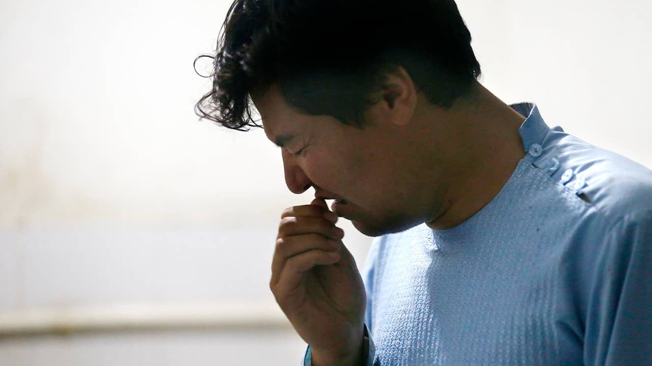 Photo of a man mourning after the death of his brother