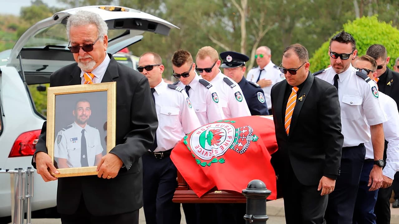 Photo of New South Wales Rural Fire Service crew members from Horsley Park RFS carrying the casket of Andrew O'Dwyer