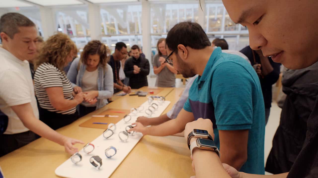 Photo of people looking at Apple Watches in New York
