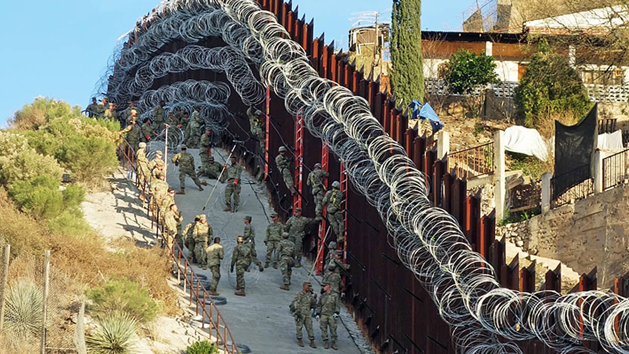 Photo of border wall in Arizona covered in razor wire