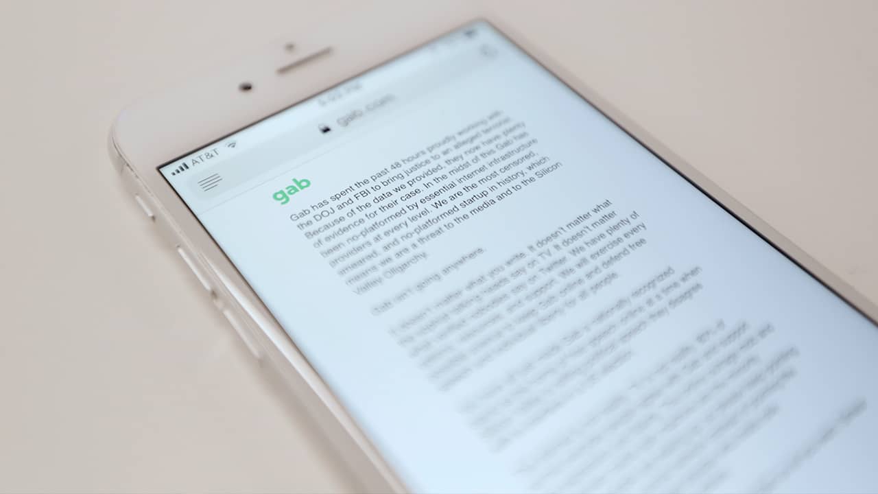 Photo of an iPhone that shows a message from Gab, a social media site