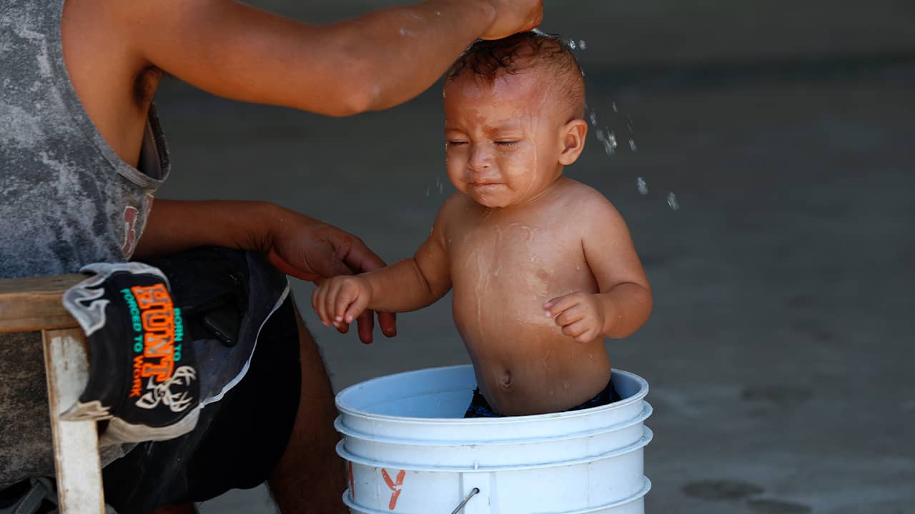 Photo of a baby getting a bath at a migrant shelter in Mexico