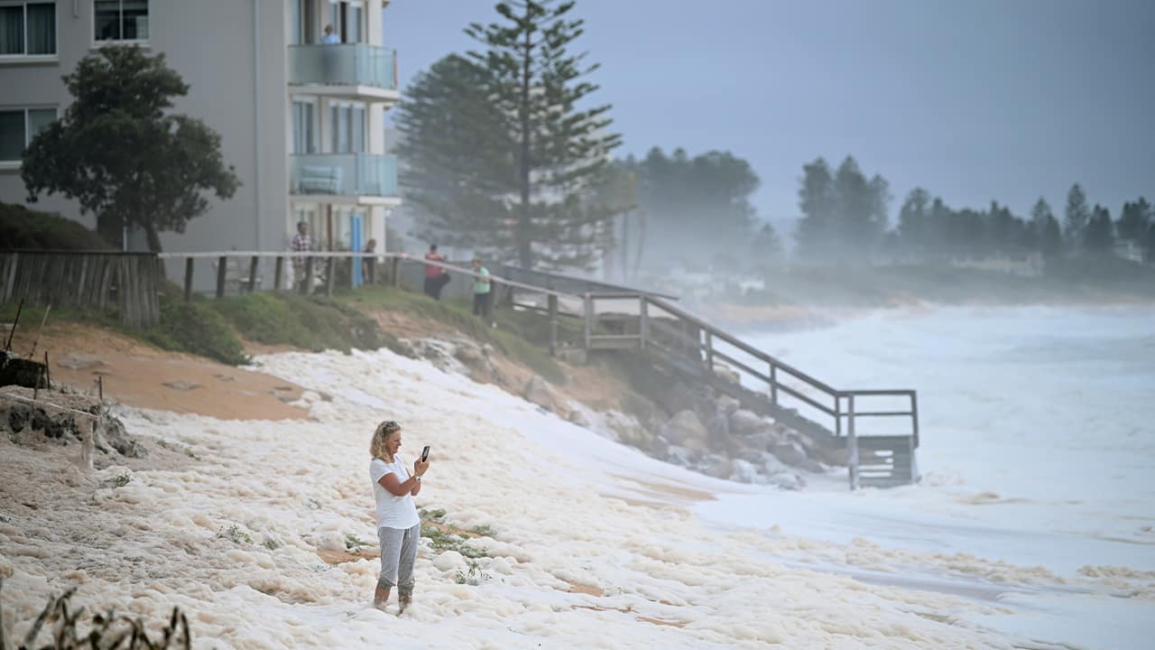 Photo of a resident looking at the see foam in Australia 