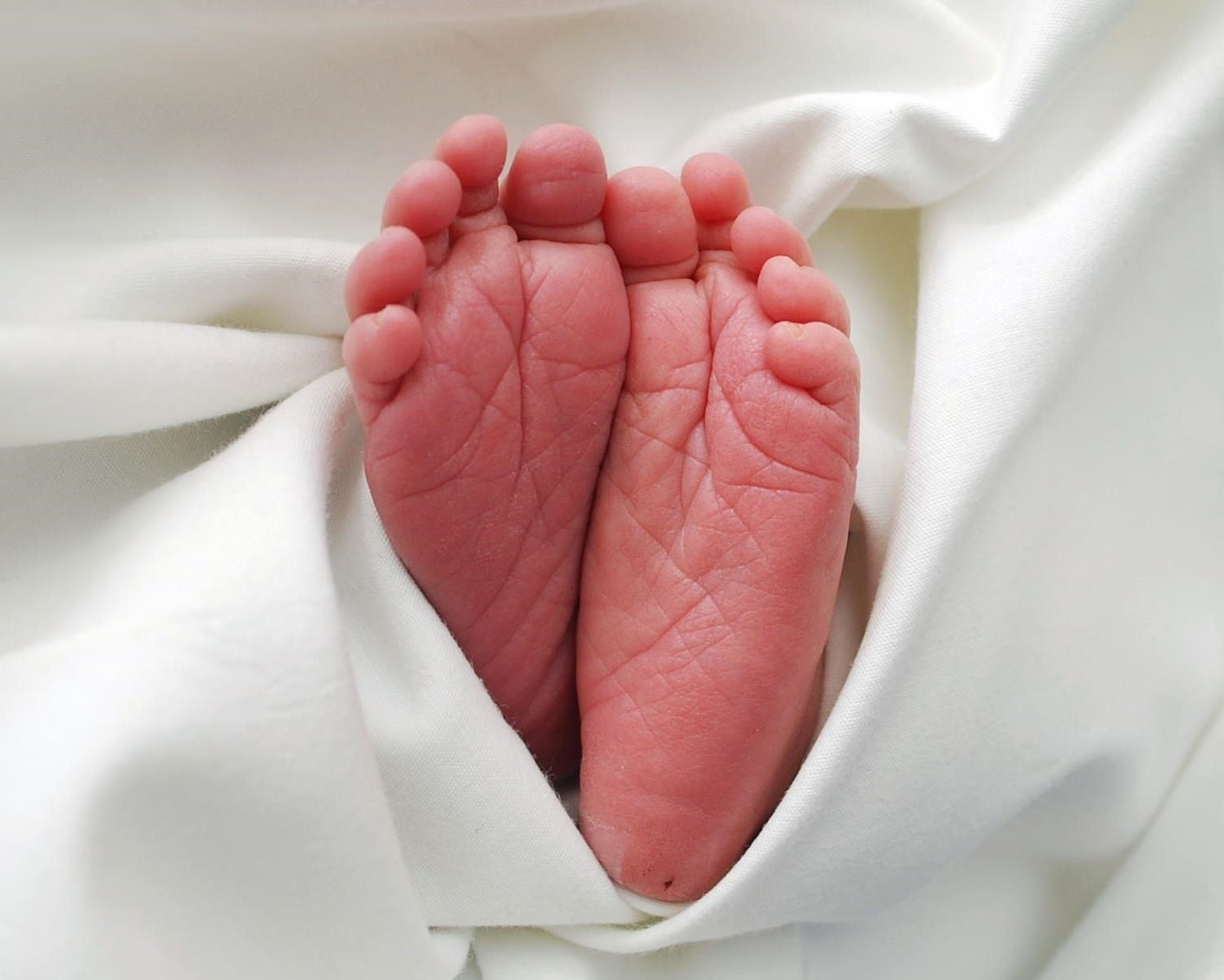 Photo of baby's feet sticking out of a blanket