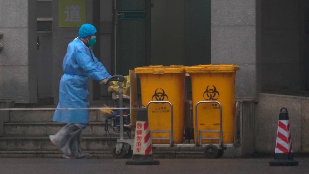 Photo of hospital staff moving bio-waste containers 