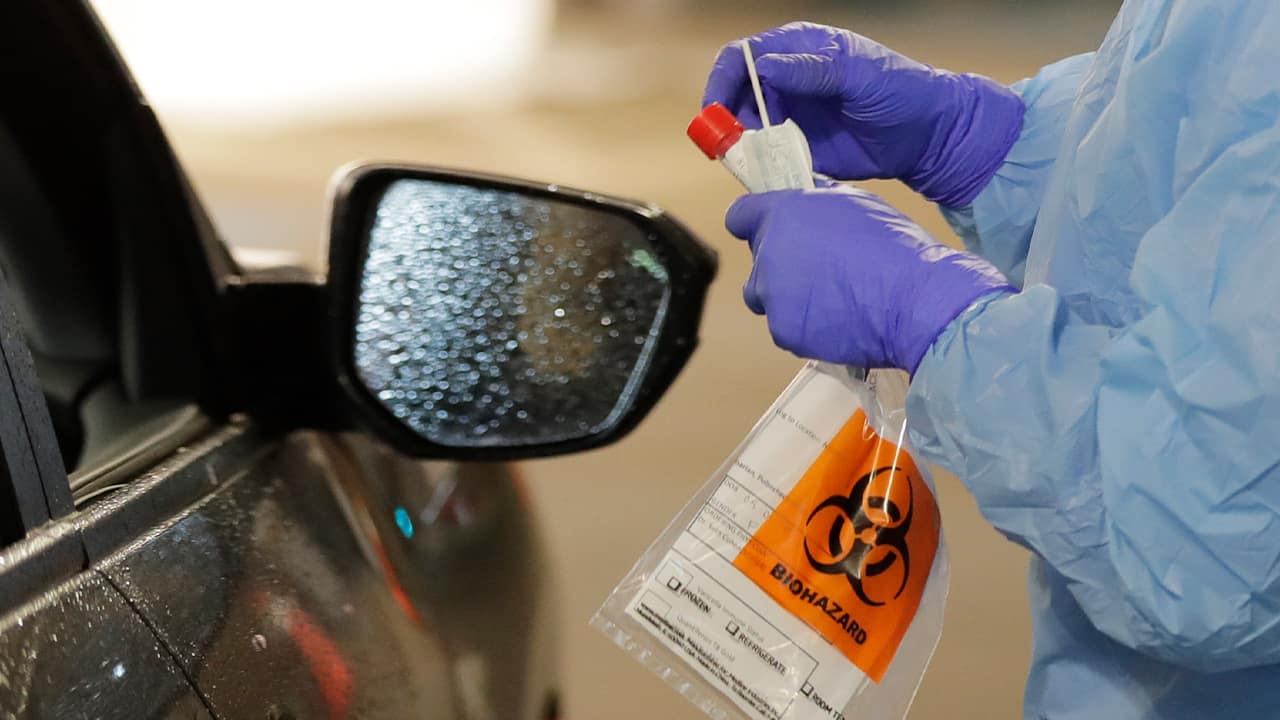 Photo of a biohazrd sign being hung on a car mirror 