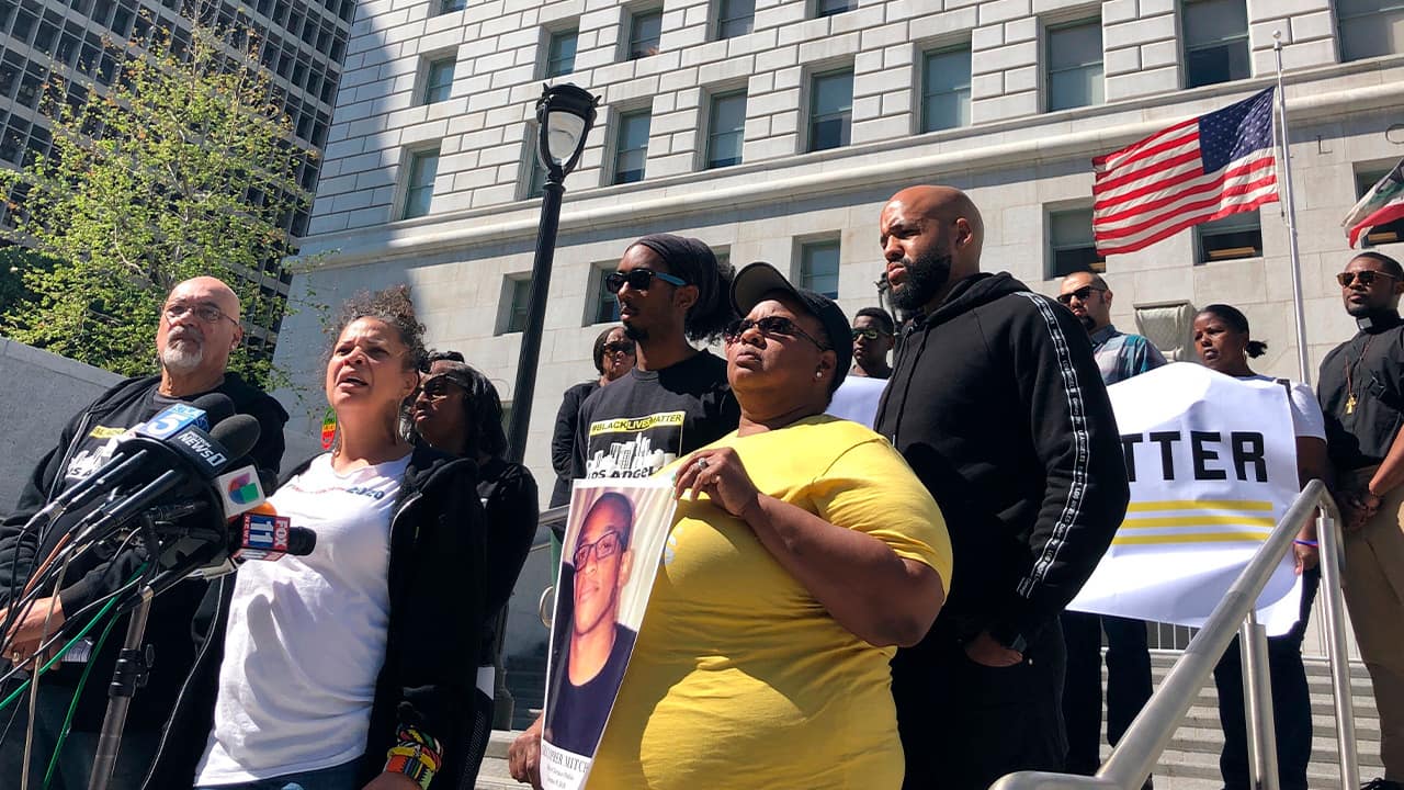 Photo of Black Lives Matter organizer Melina Abdullah, center, addressing media in downtown Los Angeles