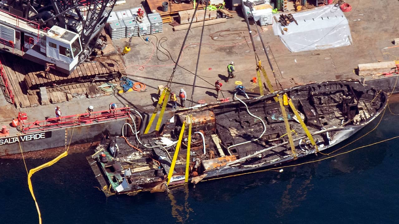 Photo of the Conception being brought out of the water by a salvage team