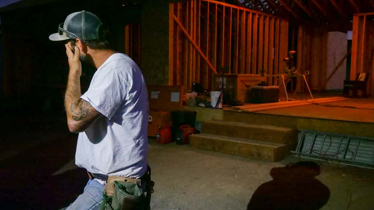 Photo of Bobbie Chandler standing outside the house he is building