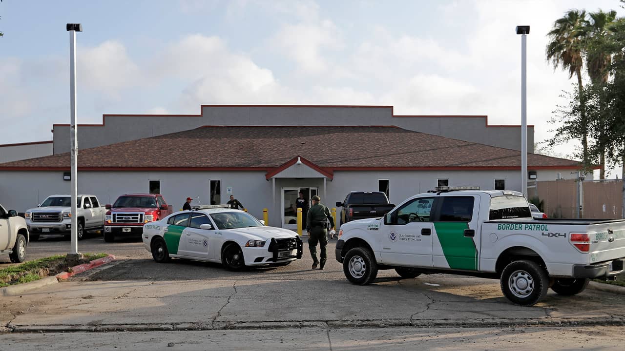 Photo of U.S. Border Patrol Agents walking near their vehicles