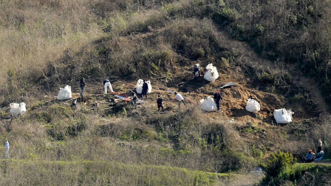 Photo of investigators working at the scene of the helicopter crash that killed Kobe Bryant