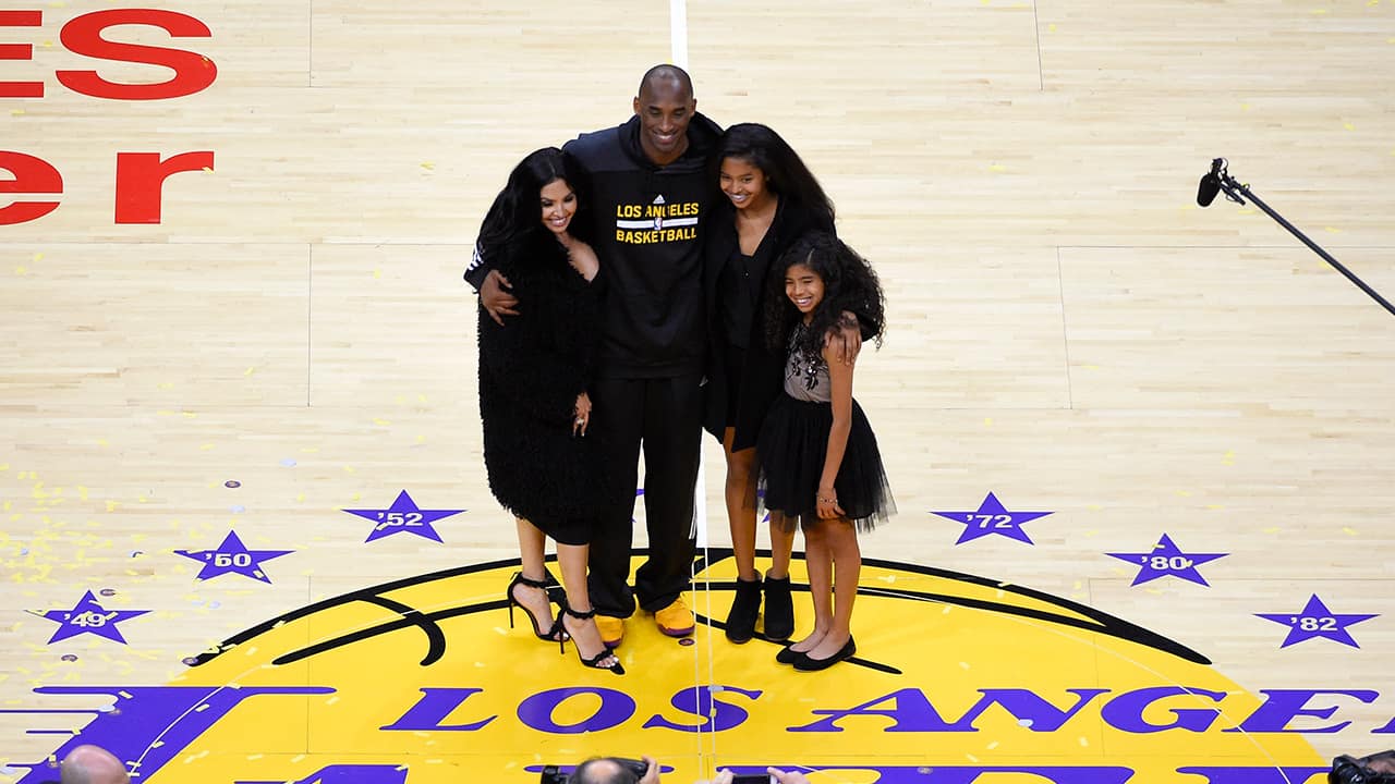 Photo of Los Angeles Lakers' Kobe Bryant poses for pictures with his wife Vanessa, left, and daughters Natalia, second from right, and Gianna