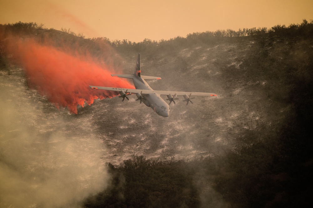 Photo of C 1 30 aircraft dropping flame retardant over Santa Barbara fire in 2017