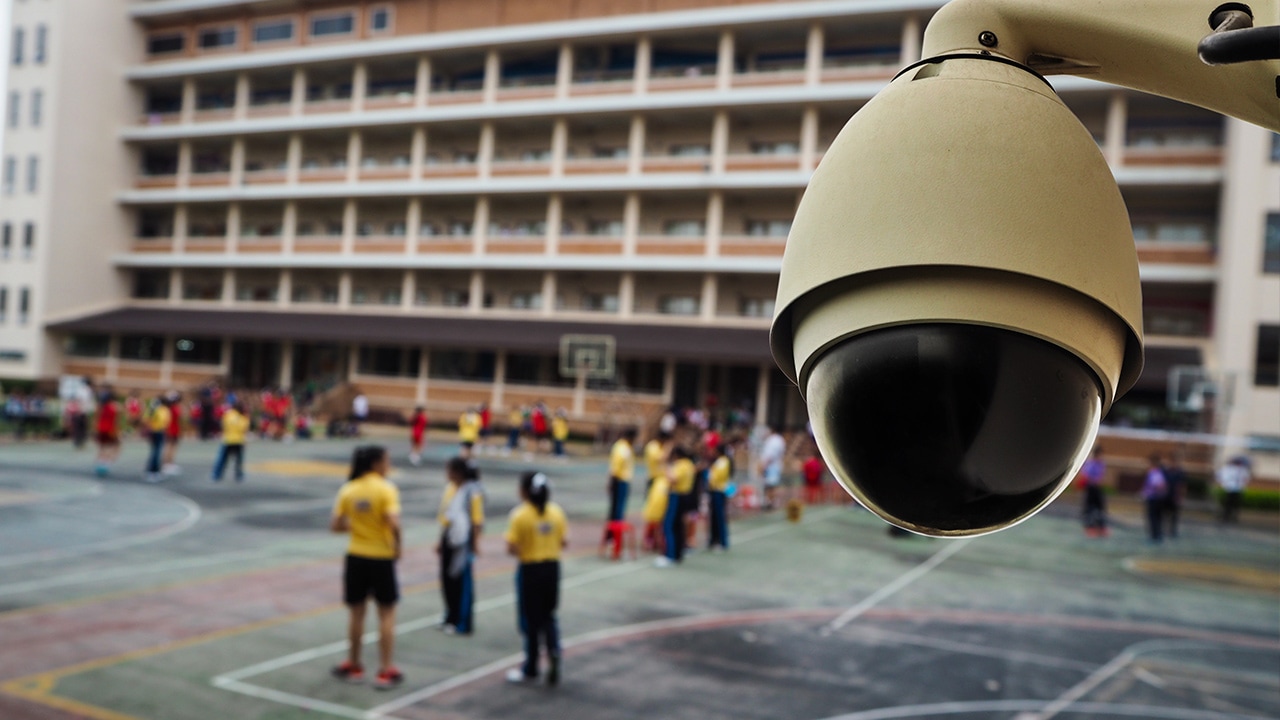 Photo of a security camera overlooking a school play yard