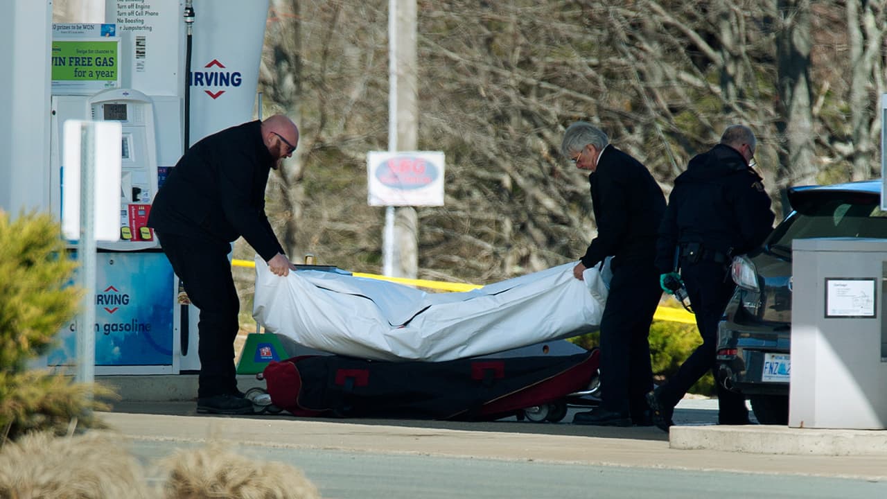 Photo of workers removing a body 