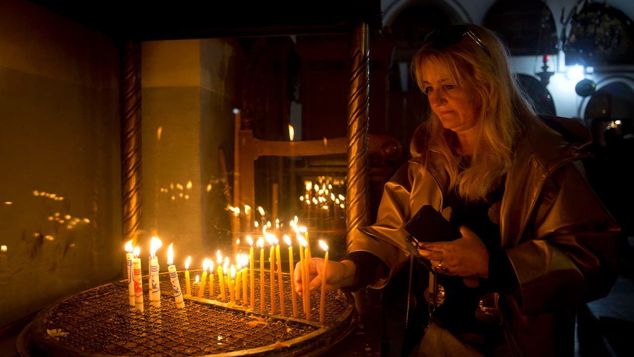 Photo of a visitor lighting candles