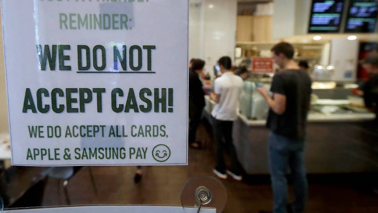 Photo of a sign informing customers that cash is not accepted