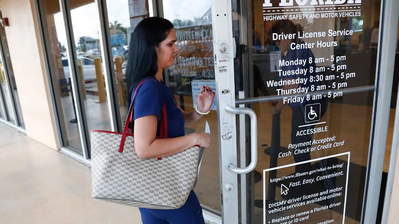 Photo of a woman entering a Florida Highway Safety and Motor Vehicles drivers license service center