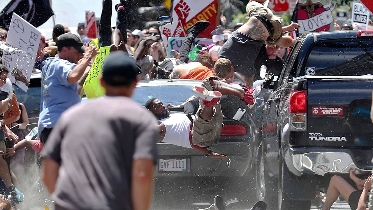 Photo of people flying into the air during a white nationalist rally in Charlottesville, Va.