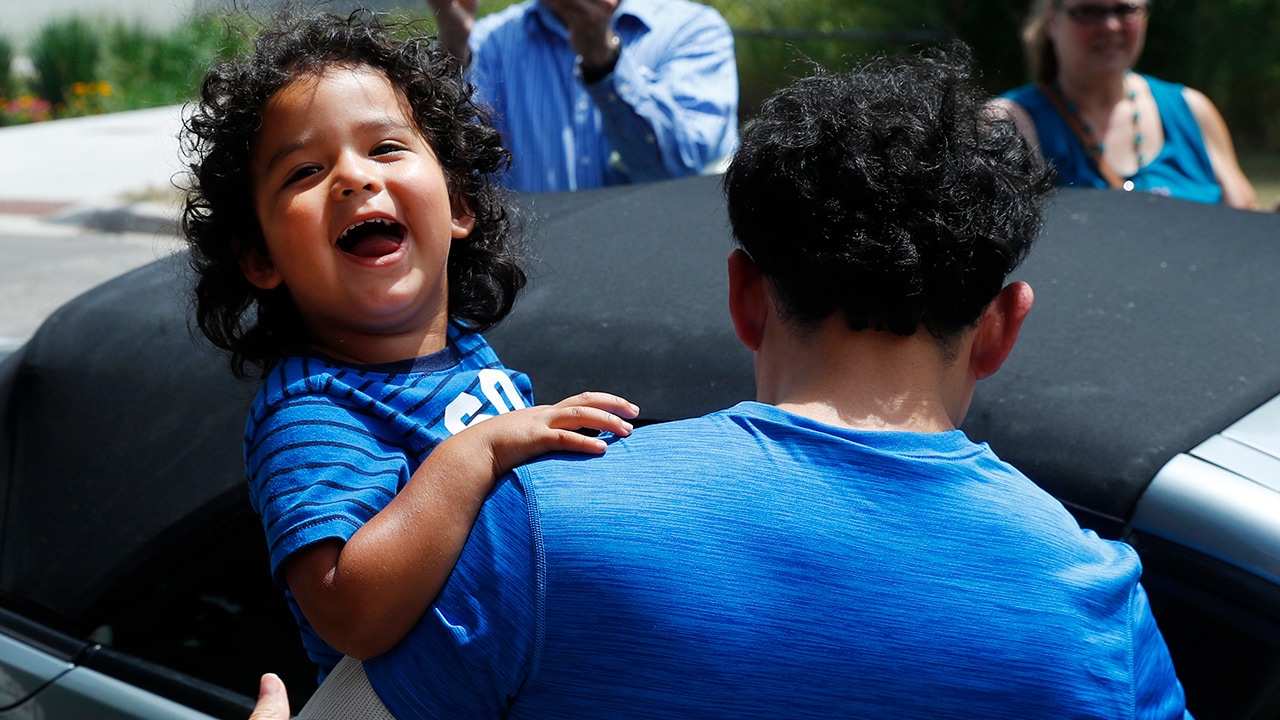 Child reuniting with his father after being released from ICE