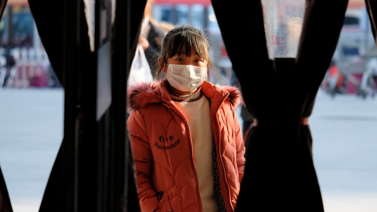 Photo of a girl standing outside of a shop in Wuhan