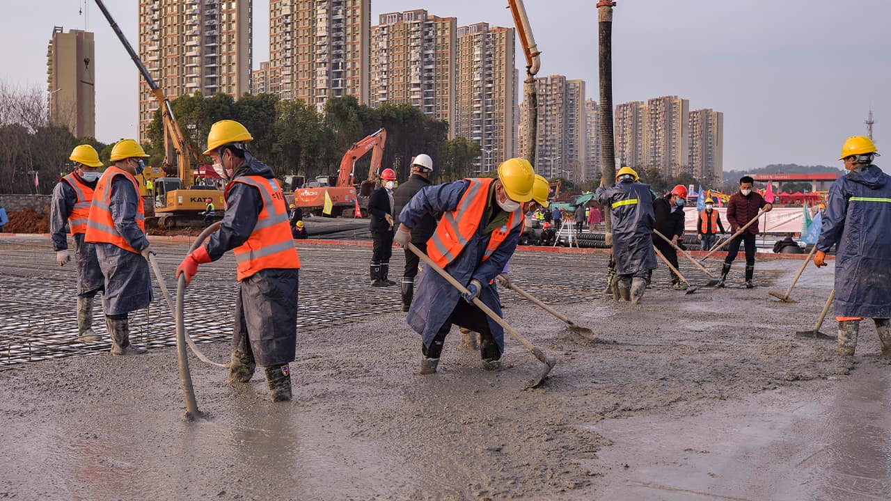 Photo of construction workers at the site of a temporary hospital 