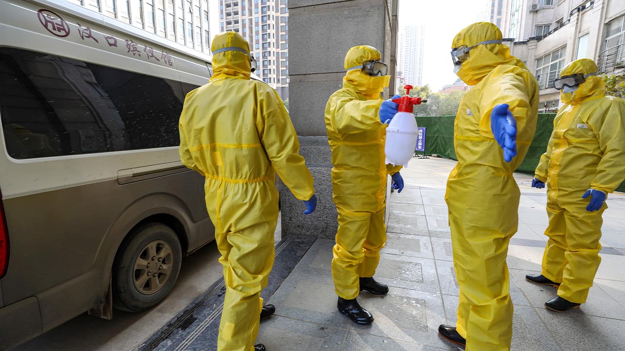 Photo of funeral workers disinfecting themselves
