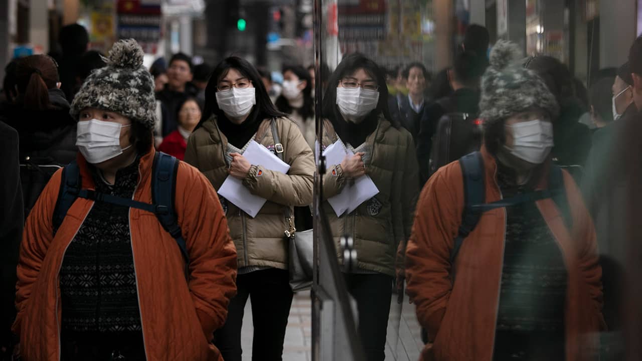 Photo of commuters wearing protective face masks