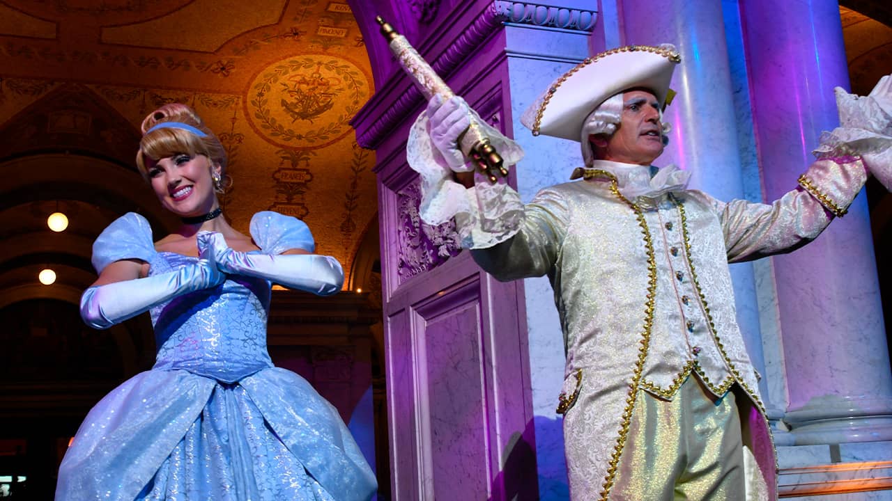 Photo of costumed Cinderella and Majordomo appear before guests