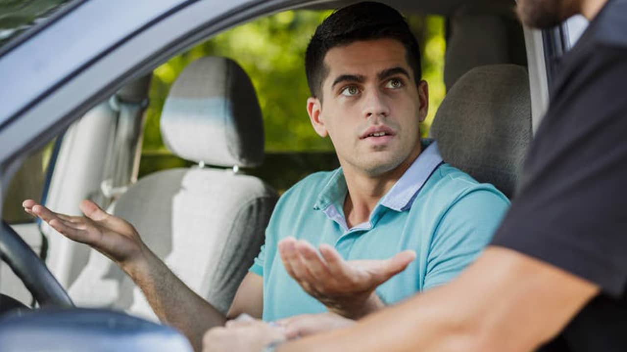 Photo of a man getting pulled over by a cop