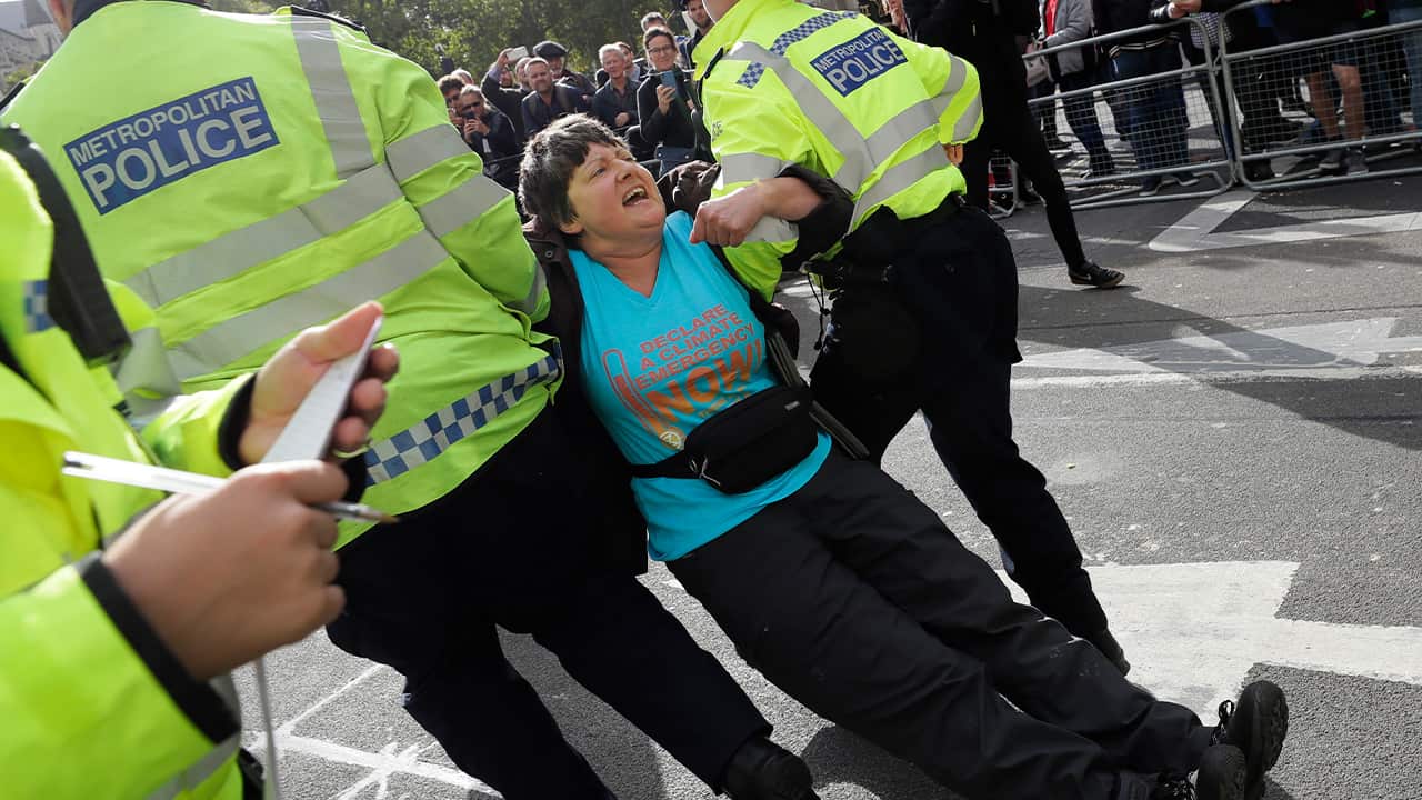 Photo of police arresting a climate demonstrator