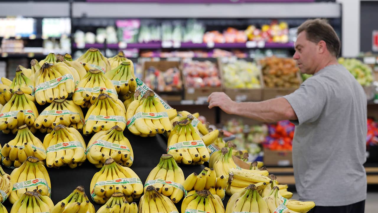 Photo of consumer shopping for bananas