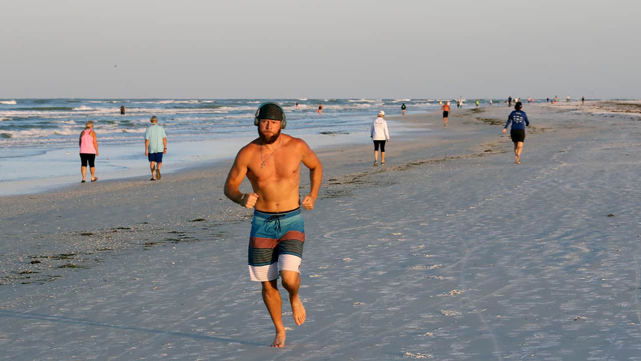 Photo of a man running on the beach in Florida 