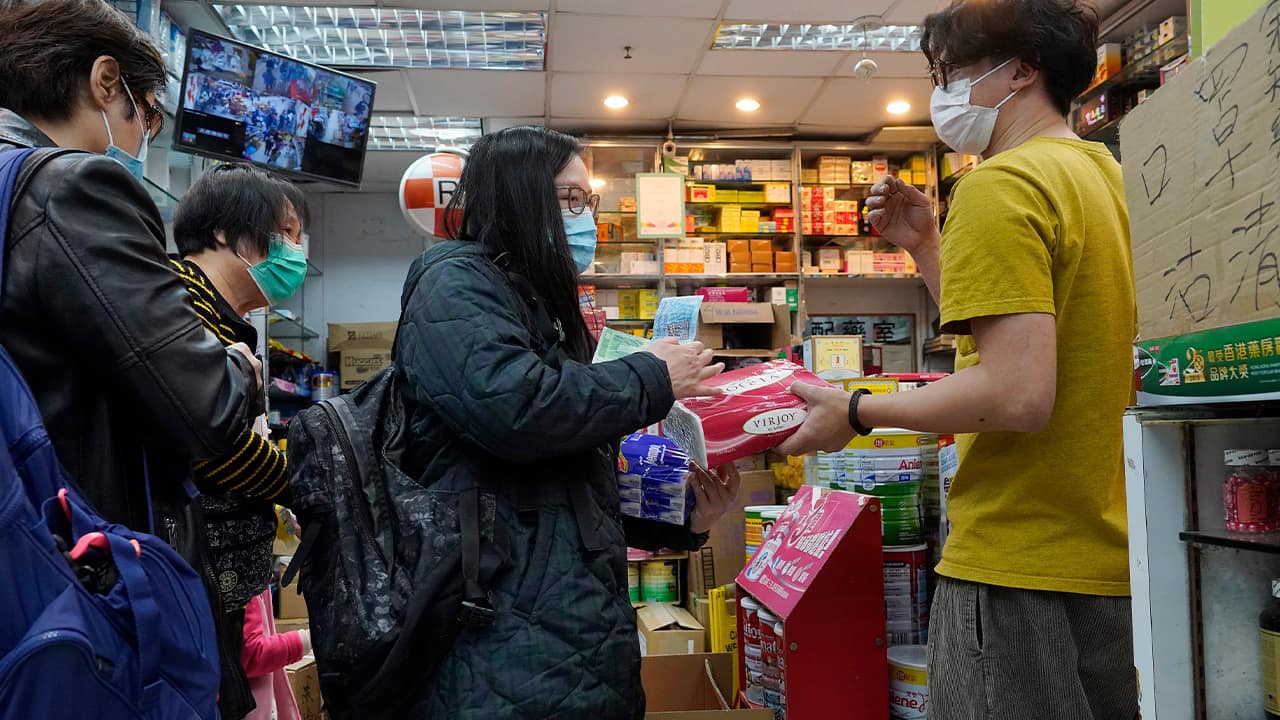 Photo of people wearing face masks at a pharmacy in Hong Kong 