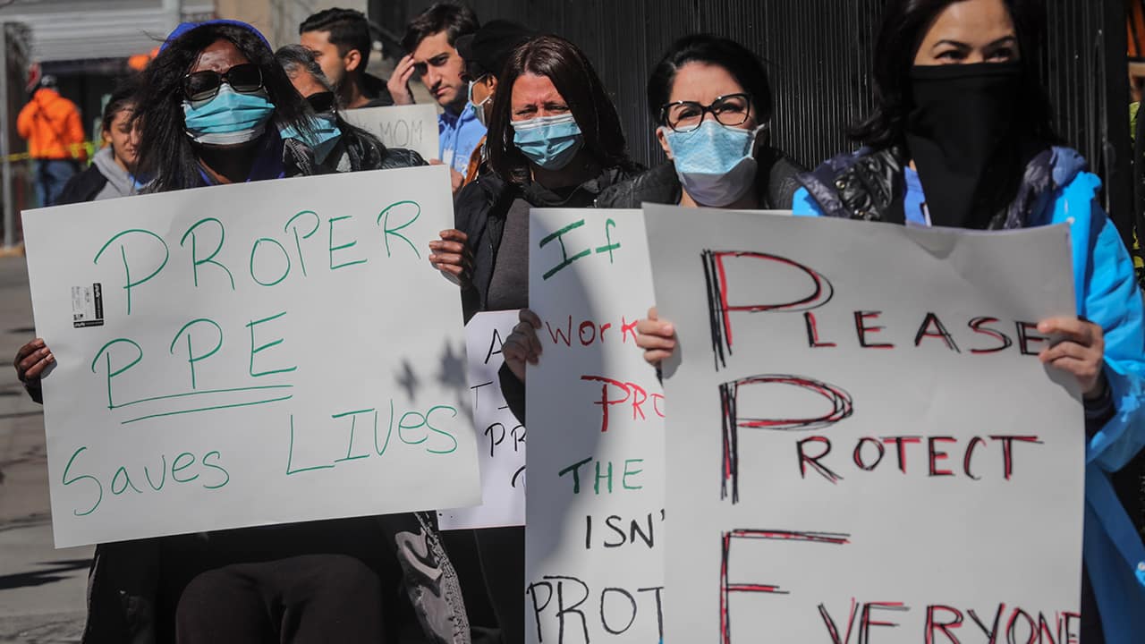 Photo of nurses holding up signs 