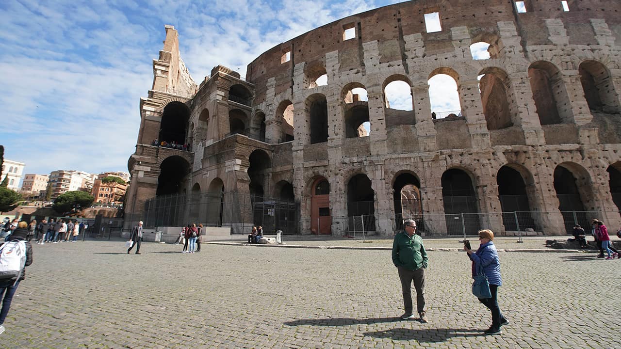 Photo of people by the Colosseum in Rome 