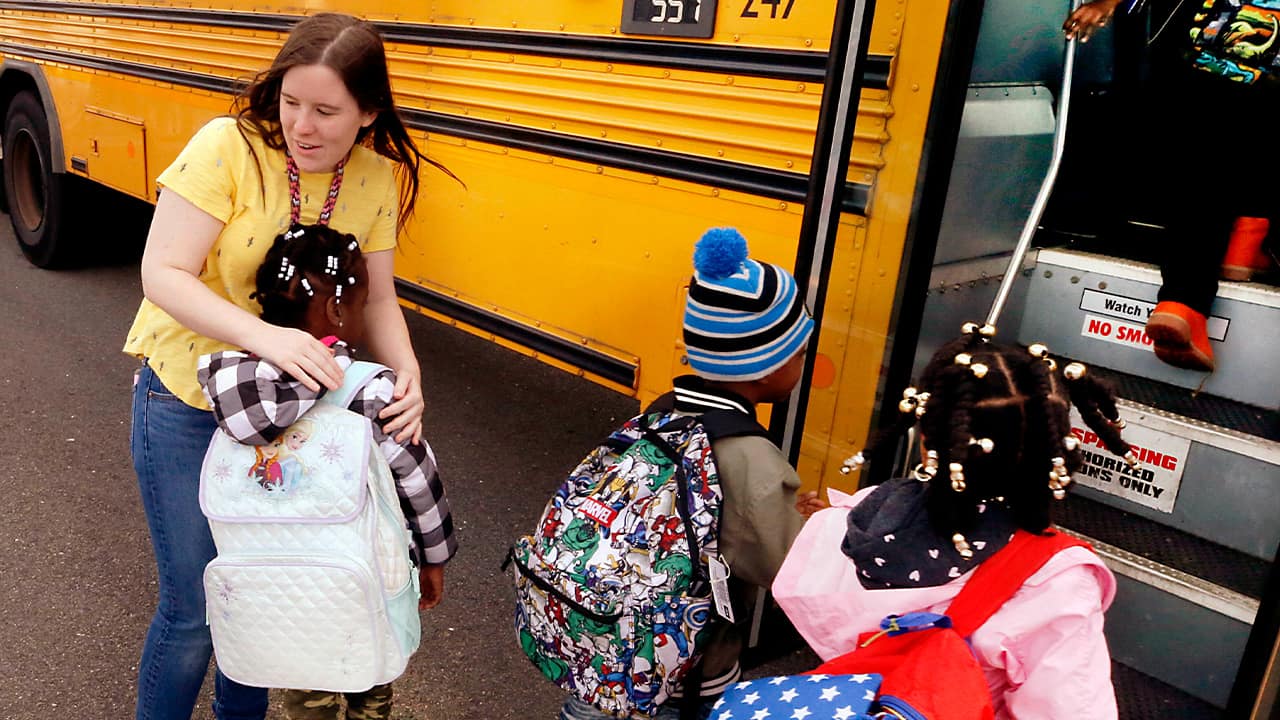 Photo of kids getting on a school bus
