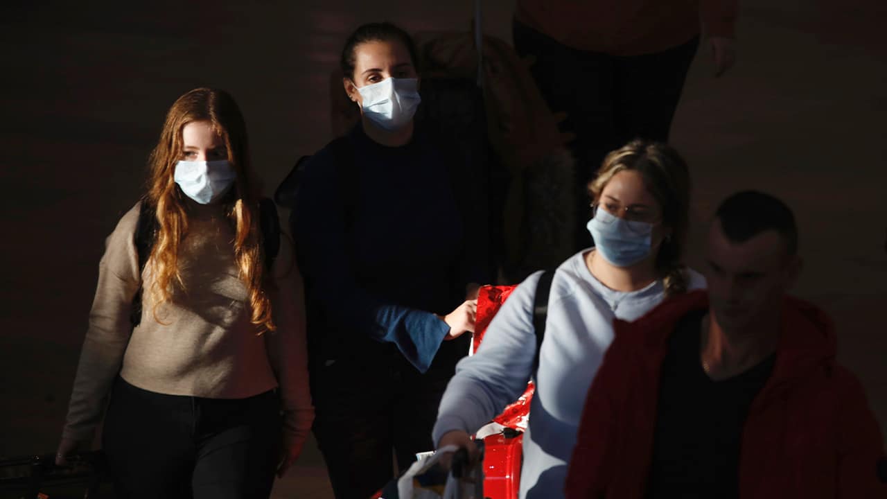 Photo of travelers wearing masks in Tel Aviv, Israel