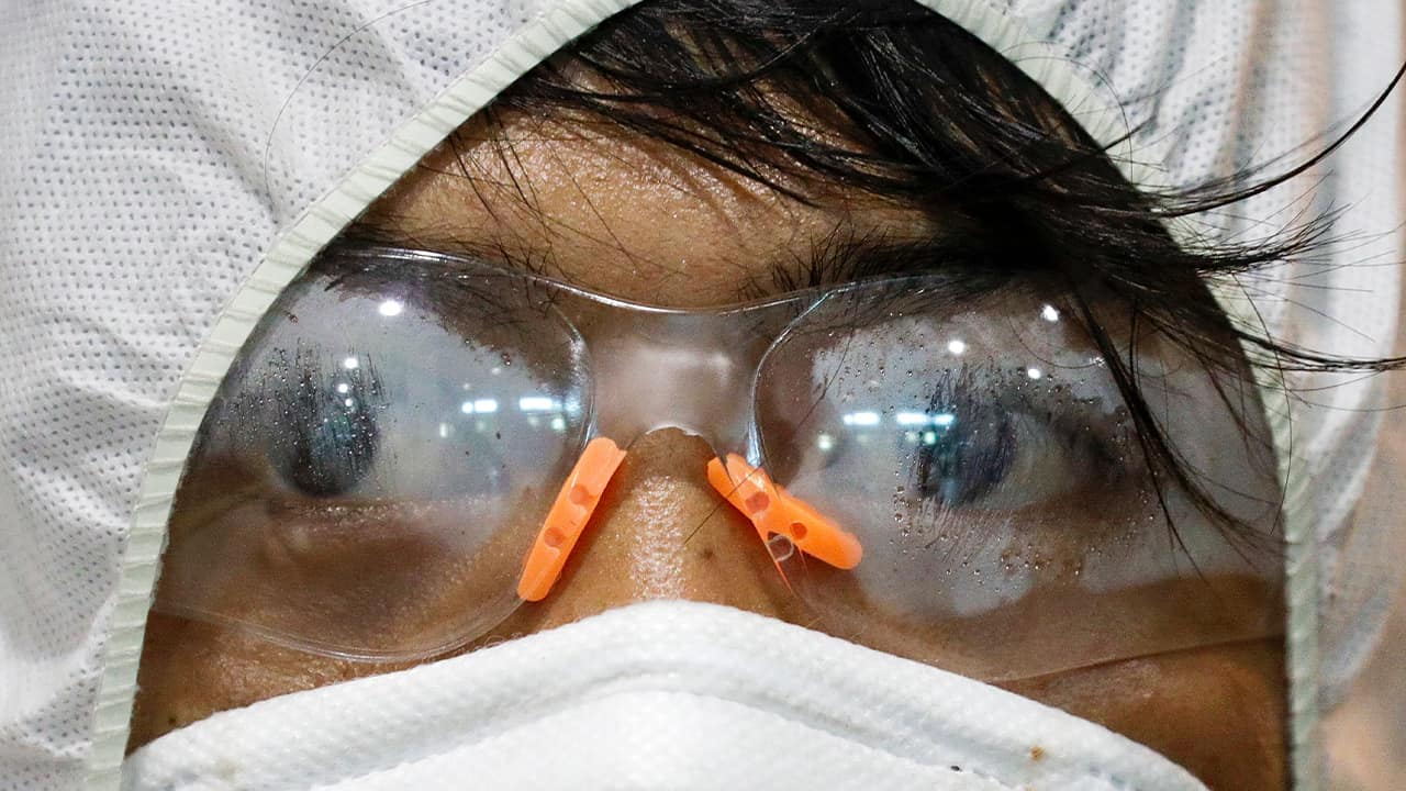 Photo of googles of a worker wearing a protective suit