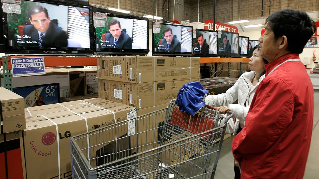 Photo of people at Costco watching The Office on the TVs