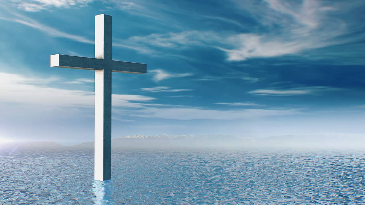 Composite illustration of a cross, blue water, and blue sky with cloudsPhot