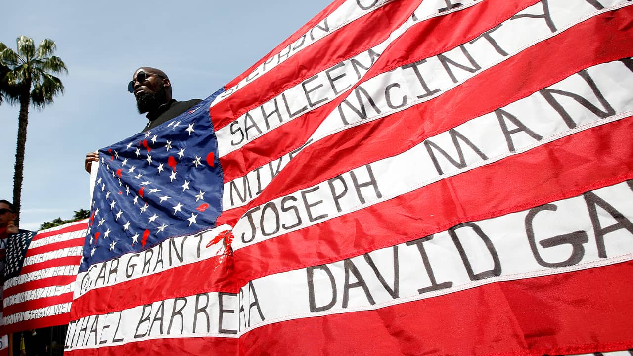 Photo of Malaki Seku holding an American flag
