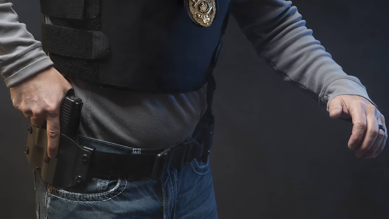 Photo of police officer holding a gun