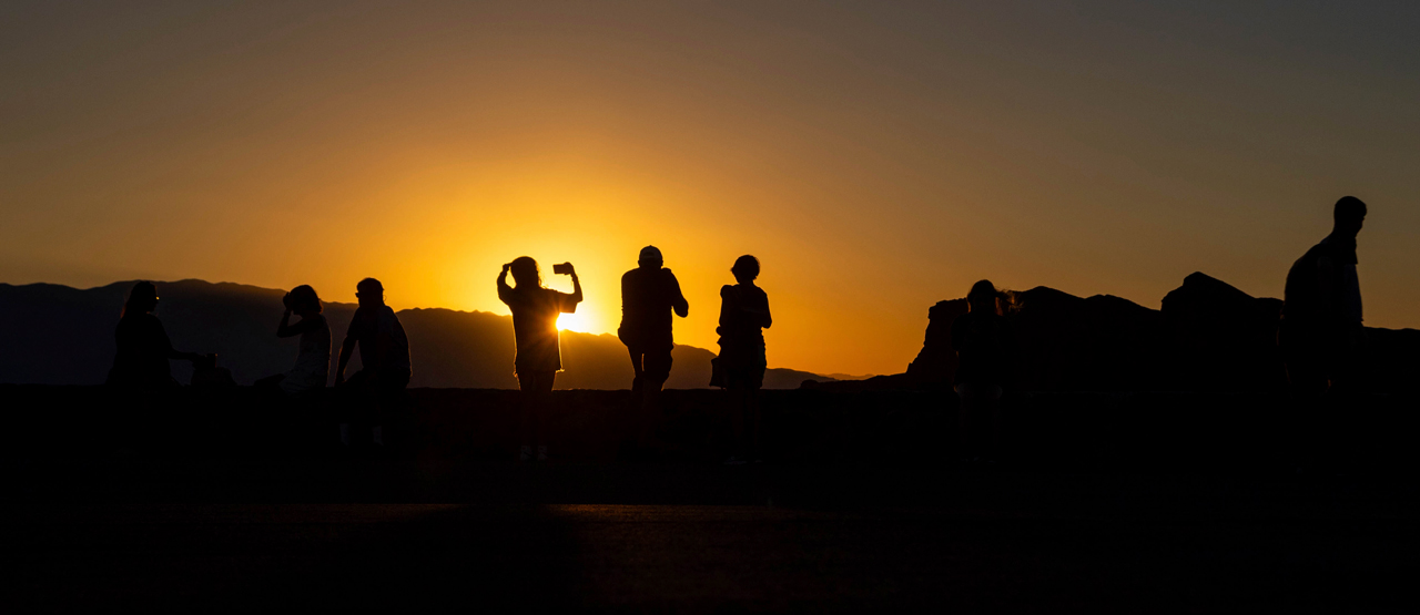 People enjoy a sunset at Zabriskie Point in Death Valley National Park, Ca