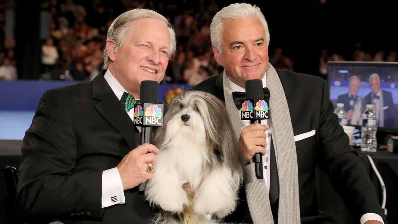 Photo of David Frei, left, and host John O'Hurley posing with a havanese dog