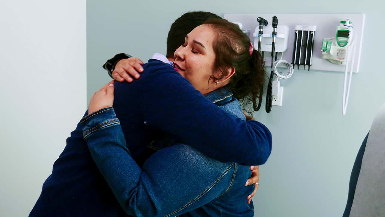 Photo of Dr. Moazzum Bajwa hugging his patient