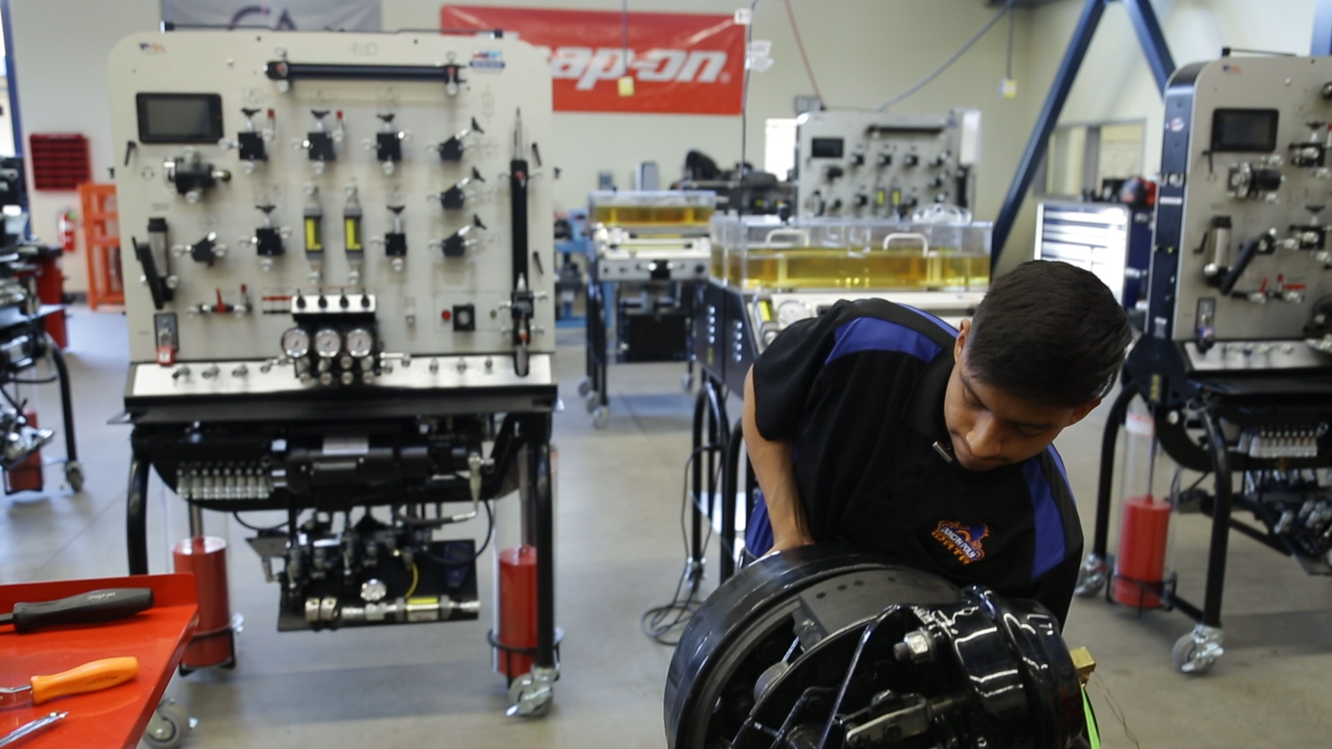 A photo of Duncan Poly student Enoc Lopez working in the school's new heavy maintenance facility