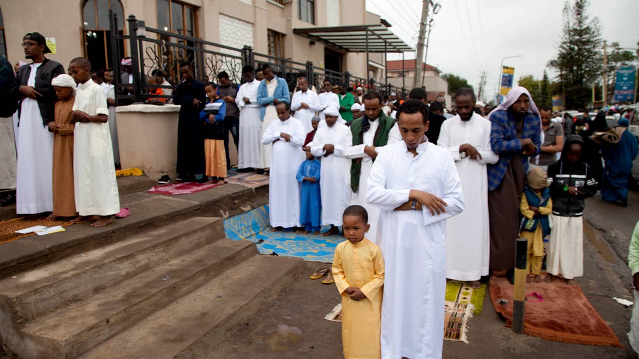 Photo of Kenyan Muslims standing for prayers outside Masjid As Salaam 