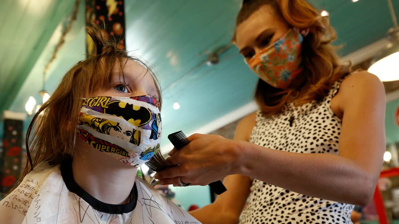 Photo of a girl getting her hair cut
